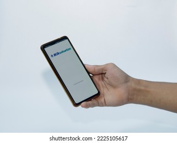 Jakarta, Indonesia - November 08, 2022: A Man Uses The BCA Securities Application On His Smartphone, A Popular Stock Trading Company In Indonesia To Buy Stocks Easily Without Coming To The Stock Excha