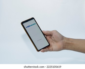 Jakarta, Indonesia - November 08, 2022: A Man Uses The BCA Securities Application On His Smartphone, A Popular Stock Trading Company In Indonesia To Buy Stocks Easily Without Coming To The Stock Excha