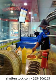 Jakarta ,Indonesia - November 14 Th 2020 ,Selective Focus Of A Pizza Vendor Busy Putting On Toppings At One Of Pizza Chains ,blurry Background