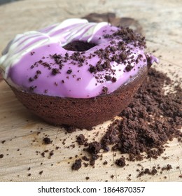 Jakarta, Indonesia - October, 2020: Chocolate Flavored Steamed Brownis Donut With Taro Glaze Topping With Oreo Biscuit Crumbs