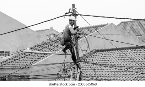 Jakarta, Indonesia - October 23, 2018: PLN workers repairing the electricity network in the city of Jakarta.