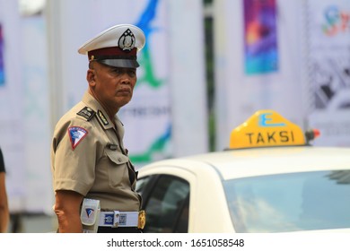 Jakarta, Indonesia - October 25th, 2014: An Old Policeman On Duty