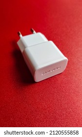 Jakarta, Indonesia On Jan 31, 2022: Defocused. Samsung Mobile Phone Charger Head Which Is White On A Red Background. Selective Focus  