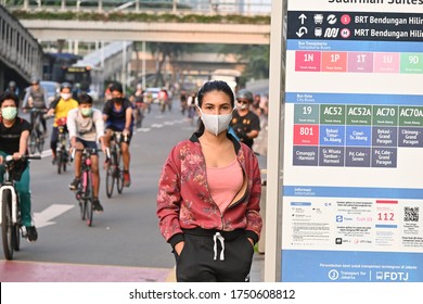 Jakarta, Indonesia On June 07, 2020: Young Asian Women Standing Infront Of Bus Destination Sign On CFD, Jakarta Wearing Facial Mask