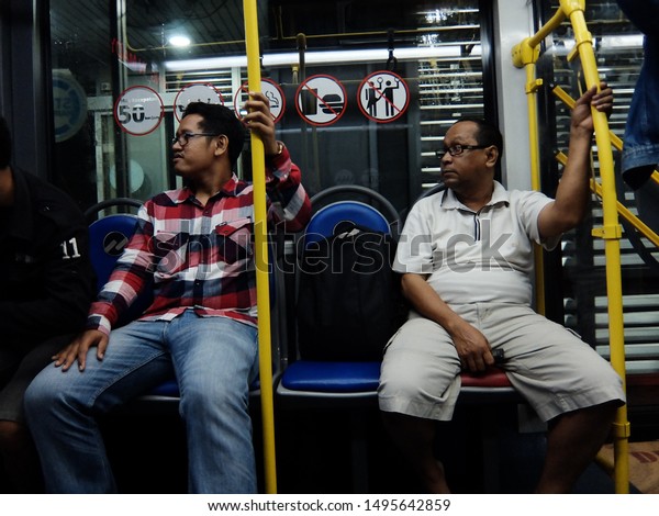 Jakarta, Indonesia : People of Jakarta\
using Busway, a single mini bus as public transportation in Blok M\
terminal, Jakarta\
(07/2017).\
\
