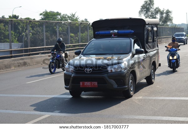 Jakarta, Indonesia - Sept 17,2020: local government\
patrol car crosses the\
road