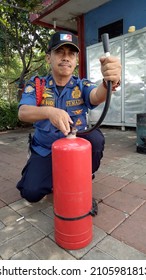 Jakarta, Indonesia - September 11, 2020 : A Firefighter Exemplifies How To Hold A Light Fire Extinguisher