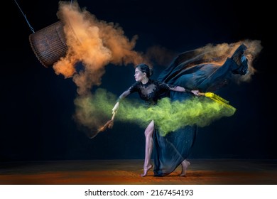 Jakarta, Indonesia-15 may 2022: A pretty dancer is dancing with a hanging drum with powder and nice dress