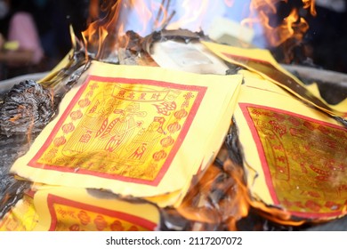 JAKARTA, INDONESIA-FEBRUARY 2022- Chinese devotees burn Joss Papers during Chinese New Year worship at the Vihara on February 01, 2022 in Jakarta.