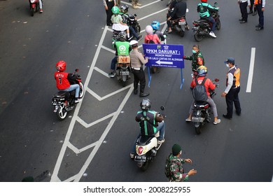 JAKARTA, INDONESIA-JULY 2021-Police turn traffic back when emergency public activity restriction (PPKM Darurat) to counter the surge of Covid-19 cases on July 15, 2021 in Jakarta.