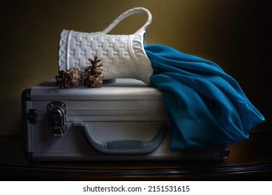 Jakarta, May 1, 2022. Tea pot, cup and blue cloth on aluminum suitcase. Fine art photography. Light painting photography. Still-life photography.                               