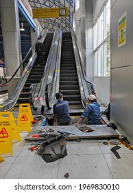 Jakarta-Indonesia, April 2021 : 2 officers repair the broken escalator at train station