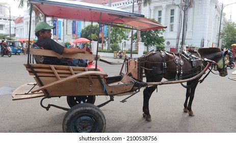 Jakarta,Indonesia - January 03,2022 - a man who drives a wagon in a corner of the city of jakarta