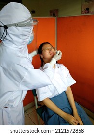 Jakarta-Indonesia, September 2021 : Noisy And Grainy Texture Swab Test Taken On A Young Lady By A Nurse At Public Health Center