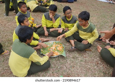 Jakarta,indonesia-august 2022:a Group Of Students Eating Together In One Big Tray With Joy And Enthusiasm