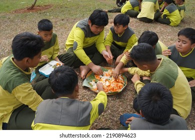 Jakarta,indonesia-august 2022:a Group Of Students Eating Together In One Big Tray With Joy And Enthusiasm