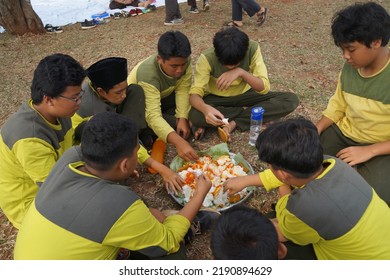 Jakarta,indonesia-august 2022:a Group Of Students Eating Together In One Big Tray With Joy And Enthusiasm