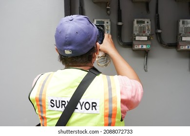 Jakarta,indonesia,november 2021,an Asian Man Is Checking Electricity Meter In Resident Area At Jakarta