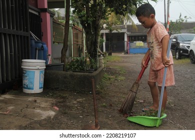 Jakarta,indonesia-september 2022:medium Indonesian Child
Cleaning Up The Environment
By Sweeping And Taking Out The Trash