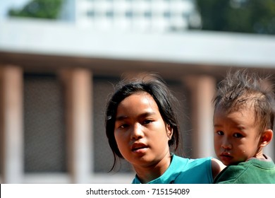 JAKARTA,INDONESI-SEPTEMBER 12,2017;  a girl carrying a boy in Jakarta.