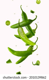 Jalapeno Pepper Levitation. White background. Hot spice, seasoning. Levitation. Lots of facilities. Abstraction. Background. Texture. There are no people in the photo. Color image.