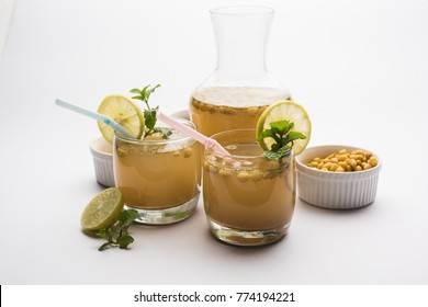 Jal-Jeera OR Jaljira is an Indian beverage prepared using mixing cumin powder in water and served cold with Boondi, Mint and Lemon slice. Served over moody background. Selective focus
