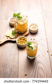 Jal-Jeera OR Jaljira is an Indian beverage prepared using mixing cumin powder in water and served cold with Boondi, Mint and Lemon slice. Served over moody background. Selective focus
