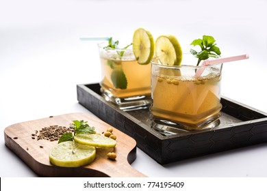 Jal-Jeera OR Jaljira is an Indian beverage prepared using mixing cumin powder in water and served cold with Boondi, Mint and Lemon slice. Served over moody background. Selective focus

