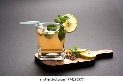 Jal-Jeera OR Jaljira is an Indian beverage prepared using mixing cumin powder in water and served cold with Boondi, Mint and Lemon slice. Served over moody background. Selective focus

