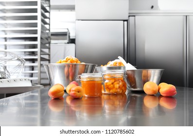 Jam From Apricots In A Glass Jar On A Polished Stainless Steel Surface In Pastry Worktop