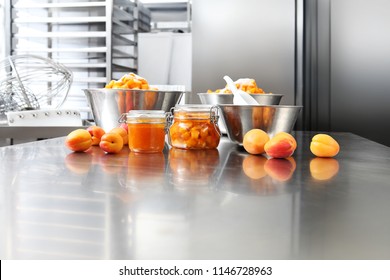 Jam From Apricots In A Glass Jar On A Polished Stainless Steel Surface In Pastry Worktop