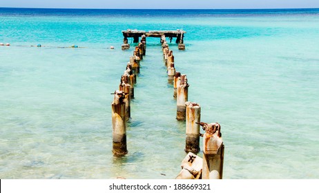 Jamaica Blue Docks 1. The remains of an old dock off a Caribbean white sand beach on the northern coast of Jamaica, near Dunn's River Falls and the town of Ocho Rios.