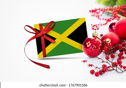 Jamaica flag on new year invitation card with red christmas ornaments concept. National happy new year composition.