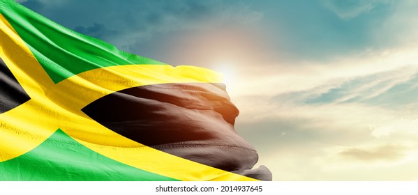 Jamaica national flag waving in beautiful sky.