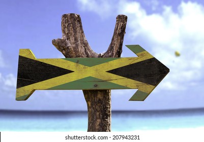 Jamaica wooden sign with a beach on background 