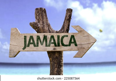 Jamaica wooden sign with a beach on background