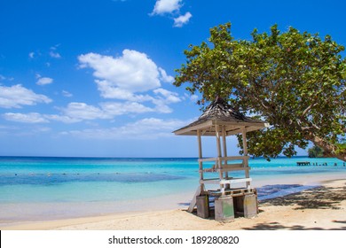 Jamaican Beach A. Caribbean white sand beach on the northern coast of Jamaica, near Dunn's River Falls and the town of Ocho Rios.