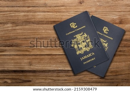 Jamaican passport on a wooden background ,The Jamaican passport is issued to citizens of Jamaica for international travel.