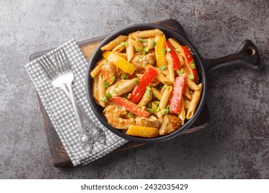 Jamaican Style Rasta Pasta Penne with Grilled Chicken and Bell Peppers closeup on the bowl on the wooden board. Horizontal top view from above
 - Powered by Shutterstock