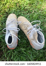 Jambi, 28th December 2019. Muddy Football Boots On The Grass