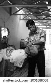 Jambi, Indonesia April 2021 : An Traditional Barber Was Shaving An Old White-haired Man In A Passageway And Kept To The Covid 19th Protocol, Photographed In Black And White Style.