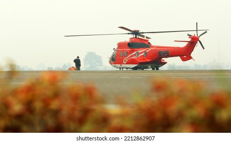 Jambi, Indonesia - September 01, 2015 : Helicopter Of  The National Agency For Disaster Countermeasure (BNPB) Is The Indonesian Board For Natural Disaster Affairs. Helicopter For Water Bombing