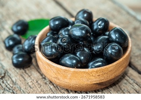 Jambolan plum, Java plum, Jambul( Syzygium cumini (L.) Skeels. on wooden background