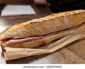 Jambon Beurre French Ham on Crispy Baguette Sandwich on a Paper Bag, Up Close - Powered by Shutterstock