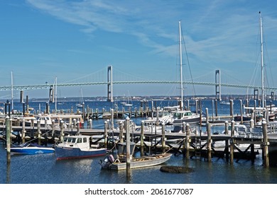 Jamestown, Rhode Island - October 21 2021: boats are moored at the Conanicut Marina with the Claiborne Pell Bridge, commonly known as the Newport Bridge, in the background.