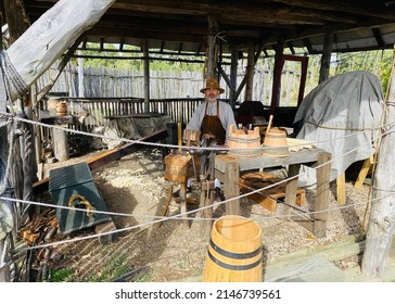 Jamestown, Virginia, United States, October 30, 2021: A Living Museum Display Showing Visitors Traditional Woodwork Process And The Traditional Attire Of Colonial Period.