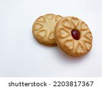 Jammy biscuit or cookie on white background. Red centered jam biscuits with strawberry flavor.