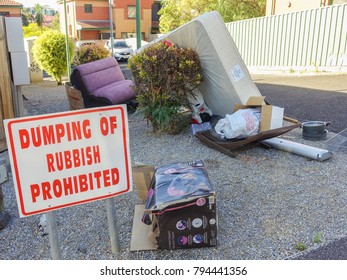 Jan 14th 2018, Hard Rubbish Including Couch And Mattress Dumped At A Site With A 'Dumping Of Rubbish Sign Prohibited' Sign On One Of Melbourne's Residential Suburban Street. Kensington, VIC Australia.