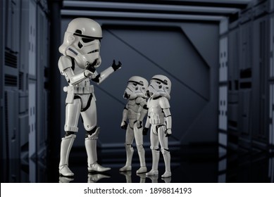 JAN 20 2021: humorous Star Wars concept of adult and child Stormtroopers with oversized helmets - Hasbro action figure