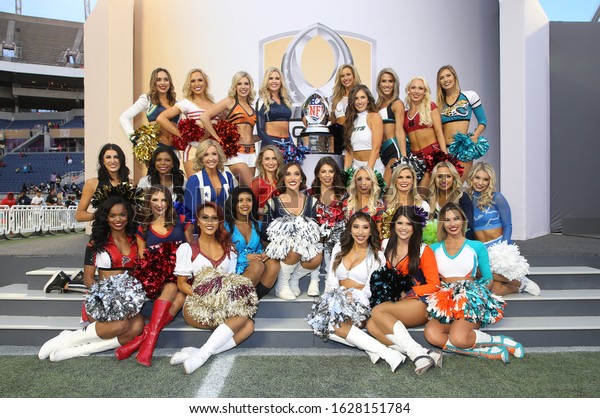Jan 26, 2020; Orlando, FL\
USA; Pro Bowl cheerleaders pose by trophy during the Pro Bowl at\
Camping World Stadium in  Orlando, Fla. (Steve Jacobson/Image of\
Sport)
